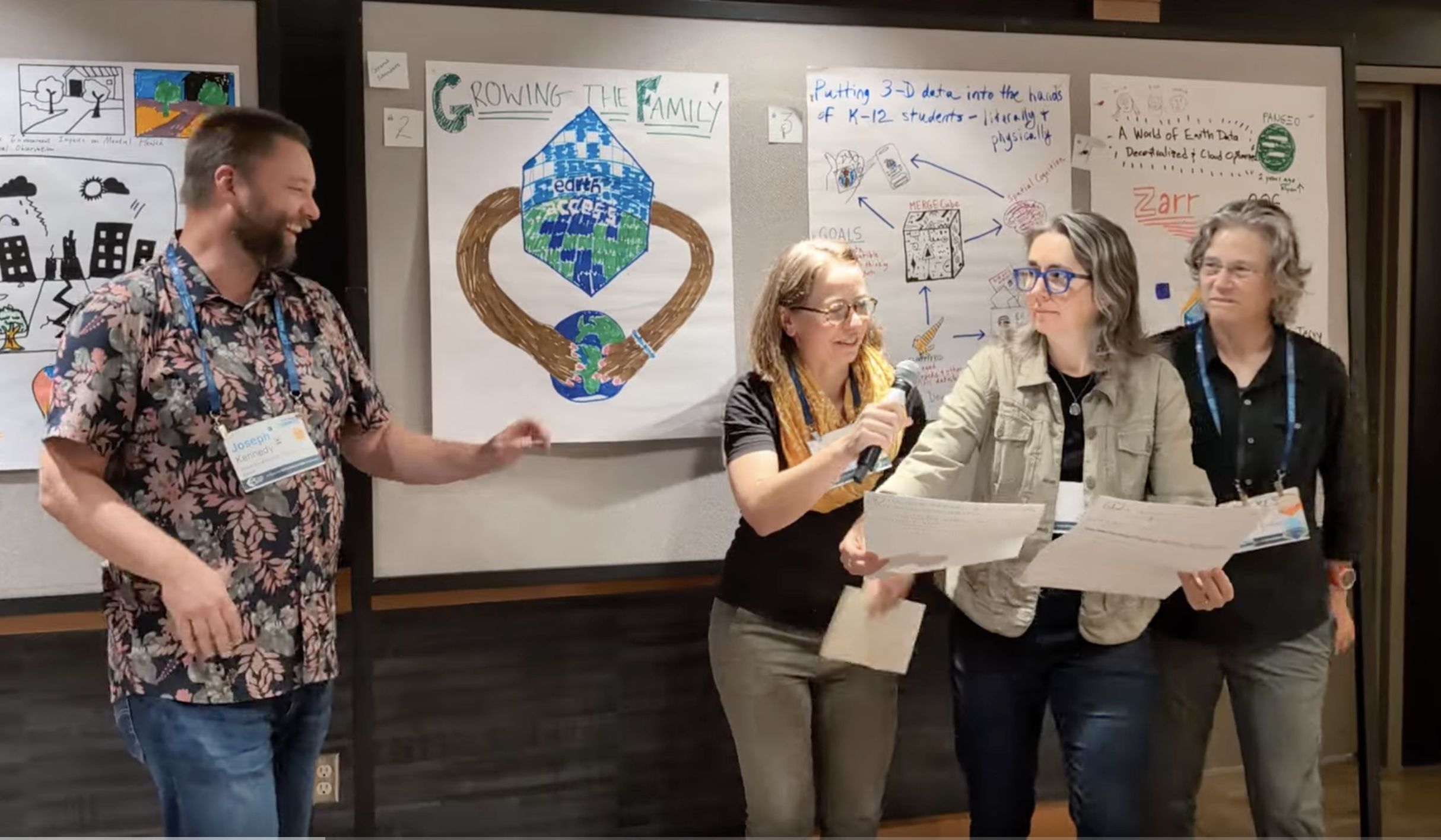 four people preparing to sing, in front of a poster with the earthaccess logo with arms hugging earth